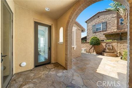 property entrance featuring a patio