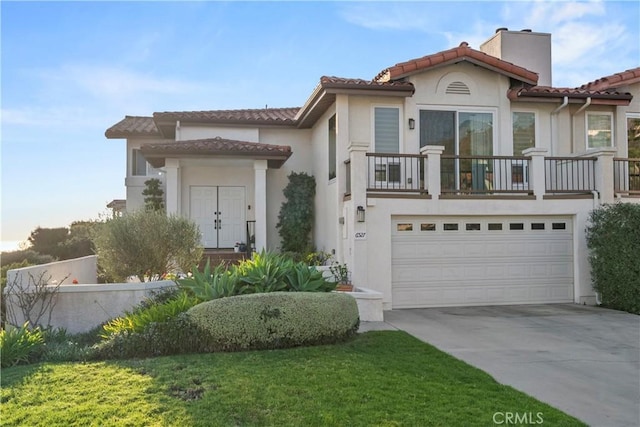 mediterranean / spanish house with a garage and a front yard