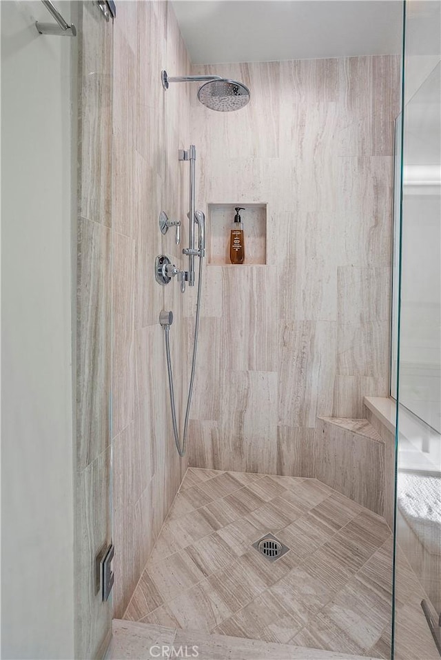 bathroom featuring a shower with shower door