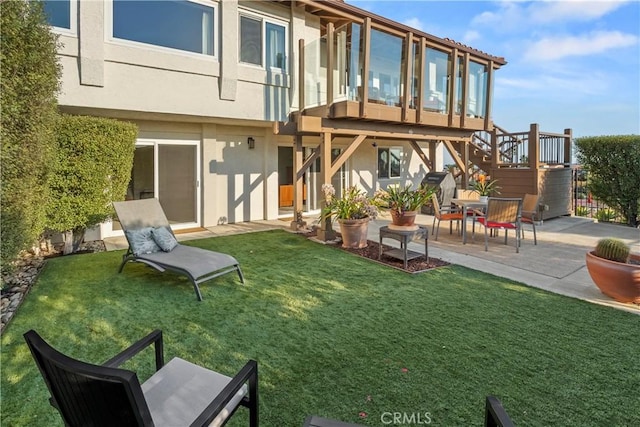 rear view of house with a patio and a yard