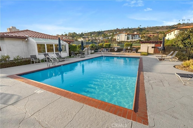 view of swimming pool with a patio area