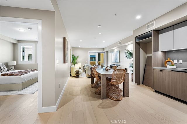 dining space featuring light wood-type flooring