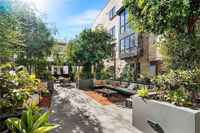 view of property's community with an outdoor living space and a patio