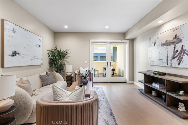 living room with light wood-type flooring and french doors