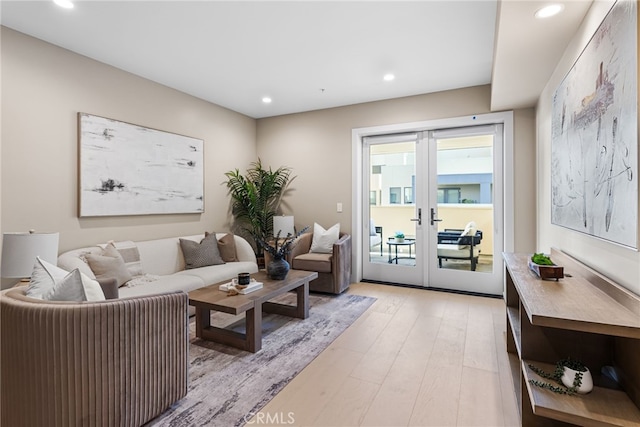 living room featuring french doors and light hardwood / wood-style floors