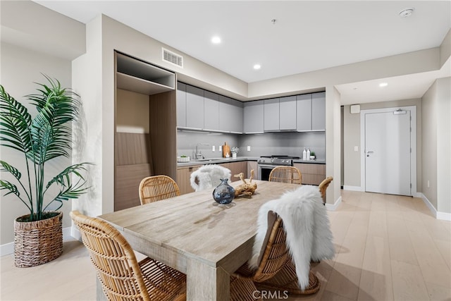 dining room featuring light hardwood / wood-style floors and sink