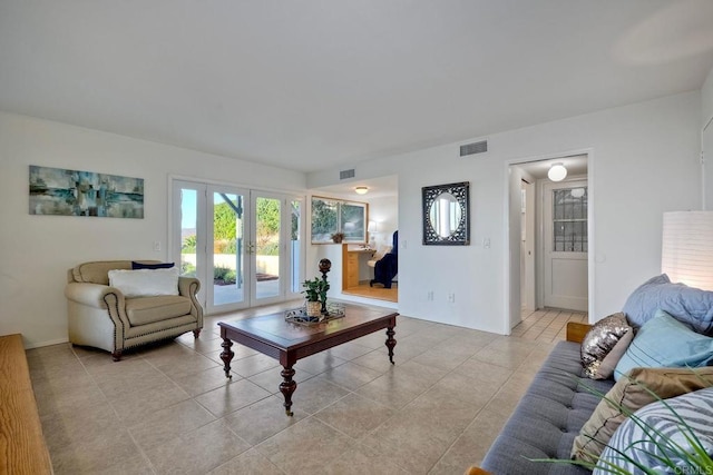 tiled living room featuring french doors