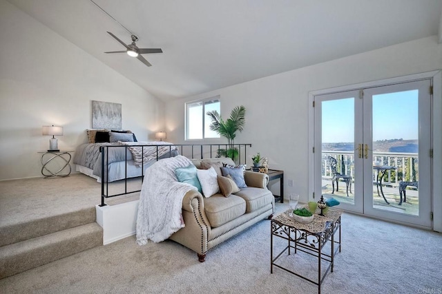 carpeted living room with a water view, ceiling fan, and high vaulted ceiling