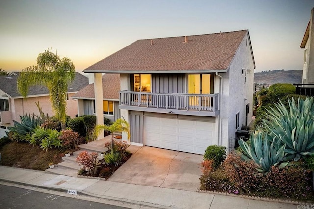 view of front of house with a balcony and a garage