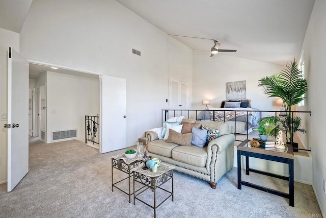 living room with ceiling fan, light carpet, and high vaulted ceiling