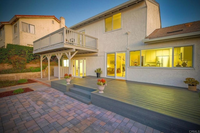 back of house featuring a balcony and a patio