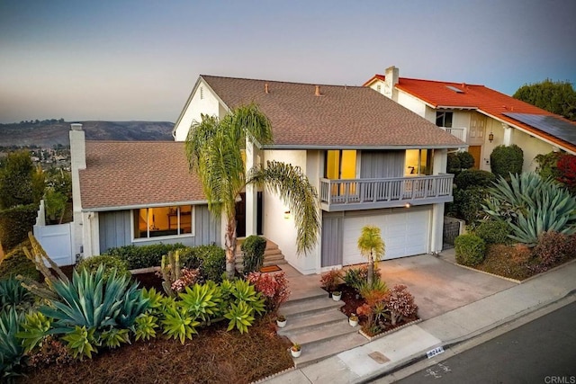 view of front of home featuring a garage and a balcony