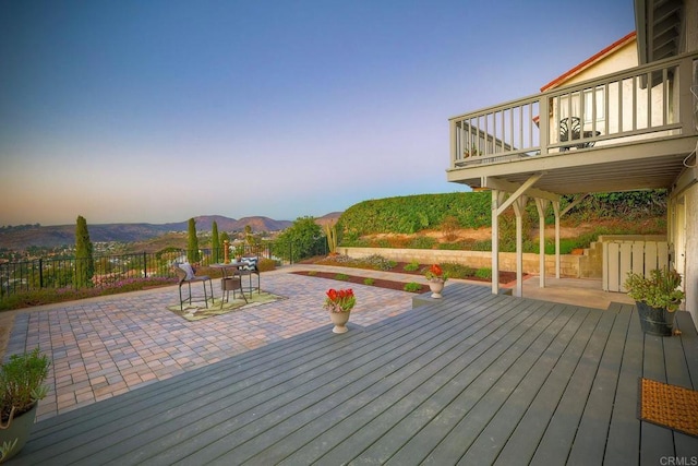 wooden terrace featuring a mountain view and a patio area