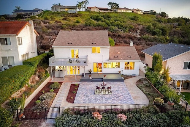 back of house with a balcony and a patio area