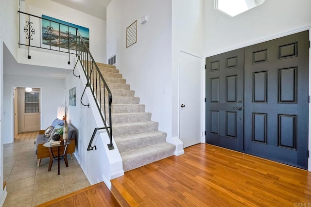 foyer with hardwood / wood-style flooring and a high ceiling