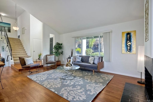 living room with vaulted ceiling and hardwood / wood-style flooring