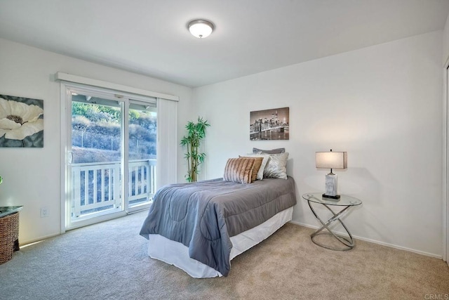 bedroom with access to outside and light colored carpet