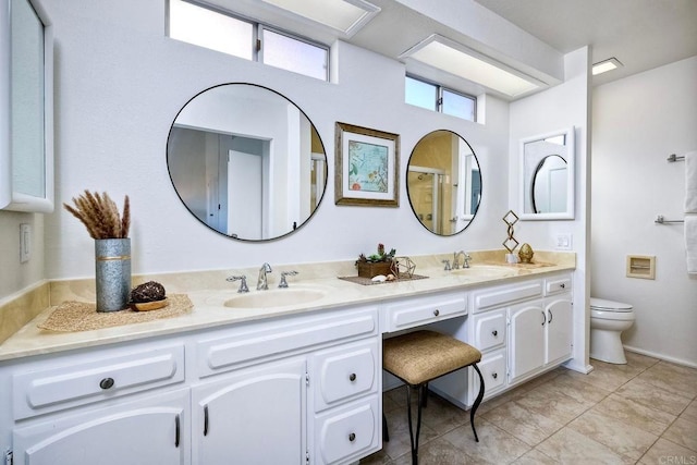 bathroom featuring toilet, tile patterned flooring, and vanity