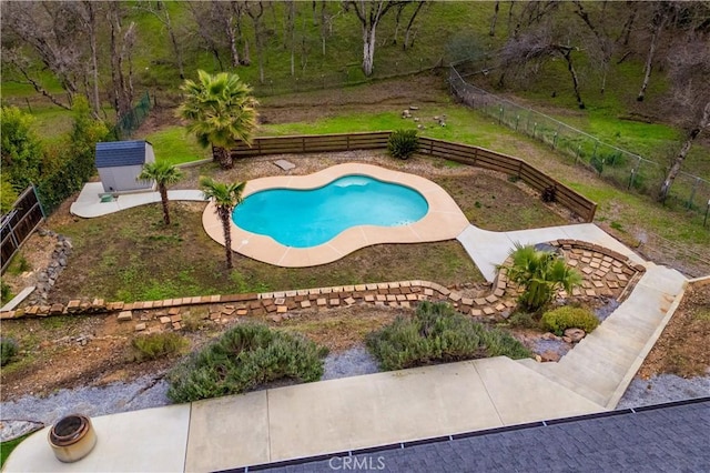 view of pool featuring a storage shed