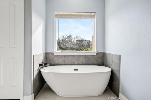 bathroom featuring a tub to relax in and tile patterned flooring