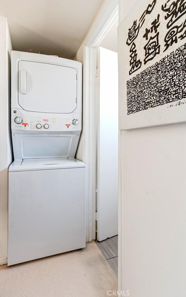 laundry area featuring stacked washer / drying machine