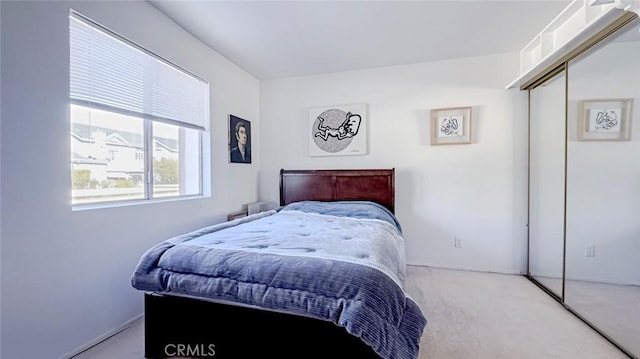 bedroom featuring light carpet and a closet