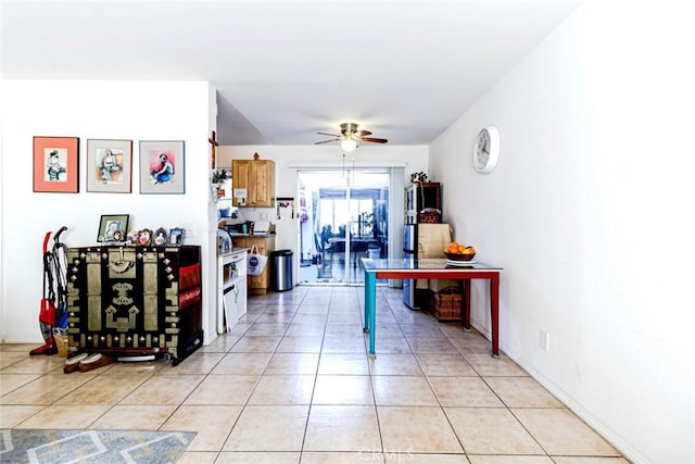 interior space with ceiling fan and light tile patterned flooring