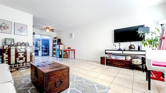 tiled living room with ceiling fan