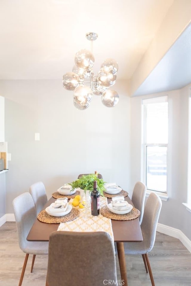 dining area featuring a chandelier and hardwood / wood-style flooring