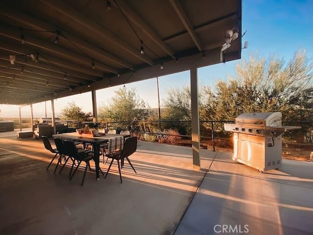 patio terrace at dusk featuring grilling area