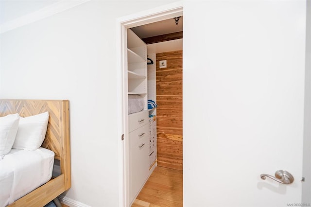 bathroom with hardwood / wood-style flooring and wooden walls