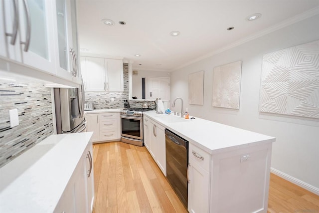 kitchen with backsplash, sink, stainless steel range with gas cooktop, black dishwasher, and white cabinetry