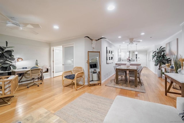 interior space with light hardwood / wood-style floors, ornamental molding, and ceiling fan