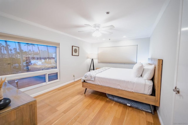 bedroom featuring ceiling fan, ornamental molding, and hardwood / wood-style flooring