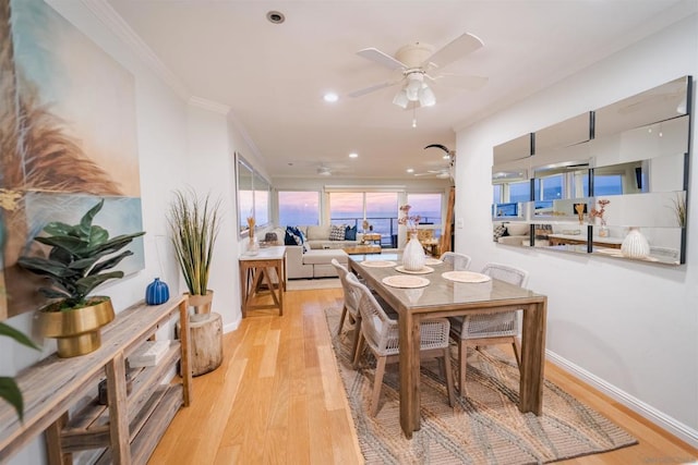 dining area featuring ceiling fan, ornamental molding, and light hardwood / wood-style floors