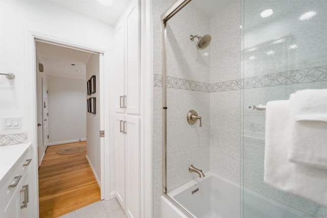 bathroom featuring tile patterned floors, shower / bath combination with glass door, and vanity