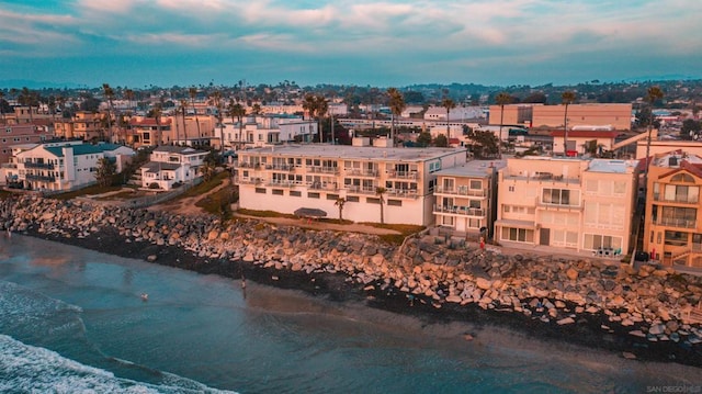 aerial view with a water view and a beach view