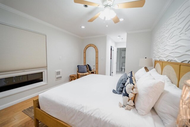 bedroom featuring ceiling fan, crown molding, and light hardwood / wood-style flooring