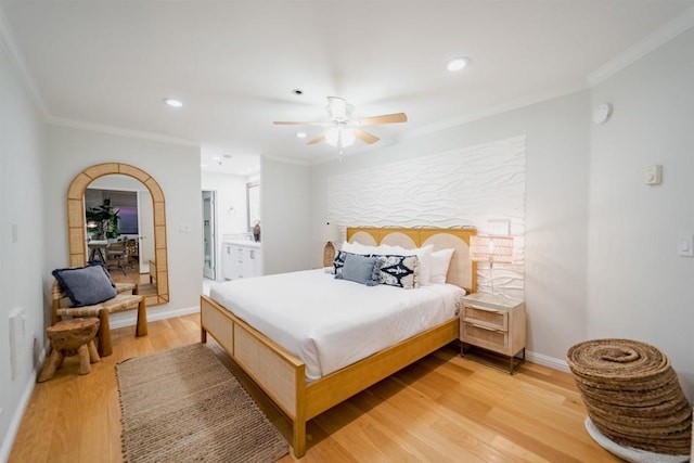 bedroom featuring light wood-type flooring, ceiling fan, ornamental molding, and ensuite bathroom