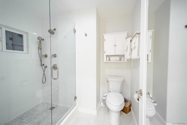 bathroom with toilet, tile patterned flooring, and a shower with door