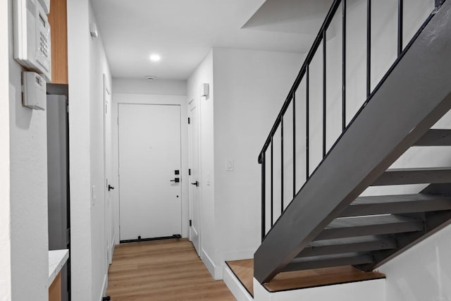 staircase with hardwood / wood-style floors