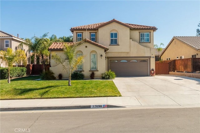 mediterranean / spanish-style house featuring a front yard and a garage