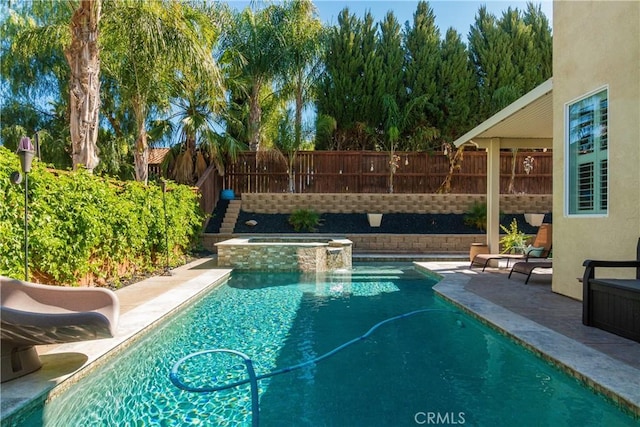 view of swimming pool featuring an in ground hot tub and a patio