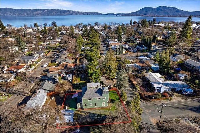 birds eye view of property with a water and mountain view