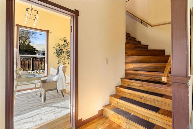 staircase with hardwood / wood-style floors