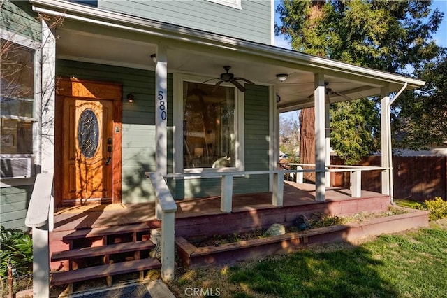 view of exterior entry featuring ceiling fan and a porch