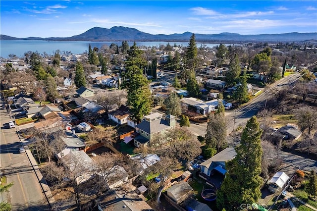 birds eye view of property with a water and mountain view