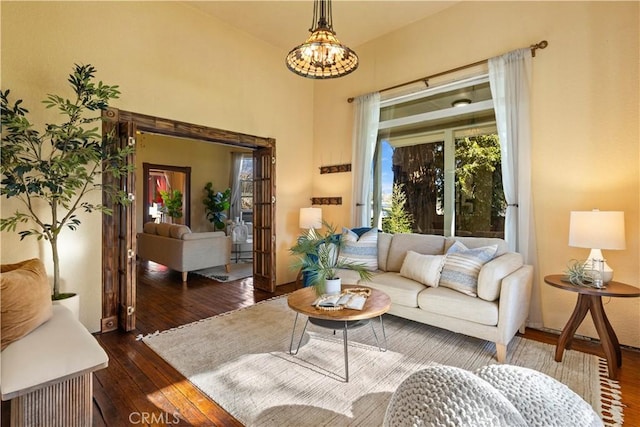 living room featuring dark hardwood / wood-style floors and an inviting chandelier