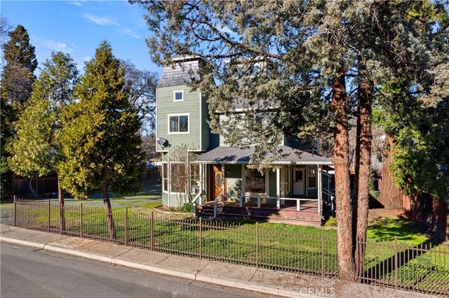 obstructed view of property with covered porch and a front yard