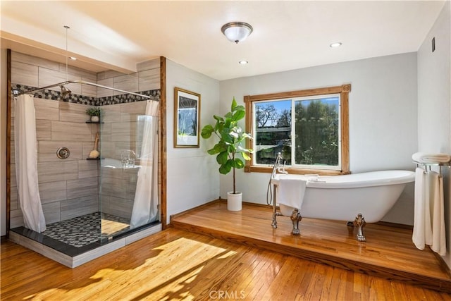 bathroom featuring independent shower and bath and hardwood / wood-style floors